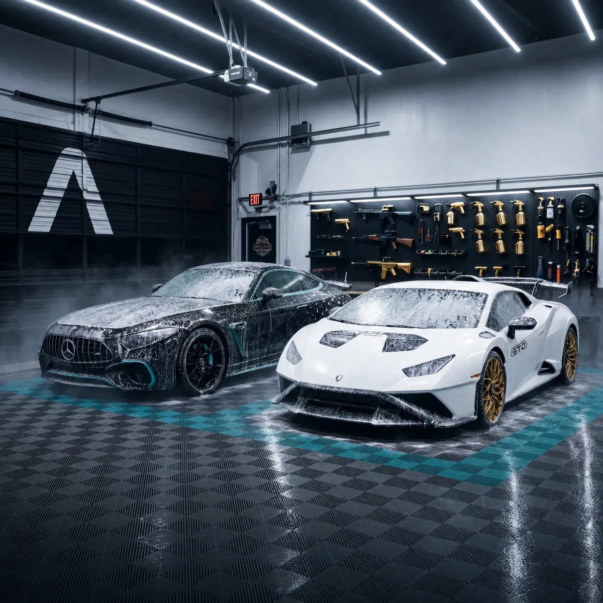 Two foamed supercars in the Apex wash bay beneath the gold finish wall
