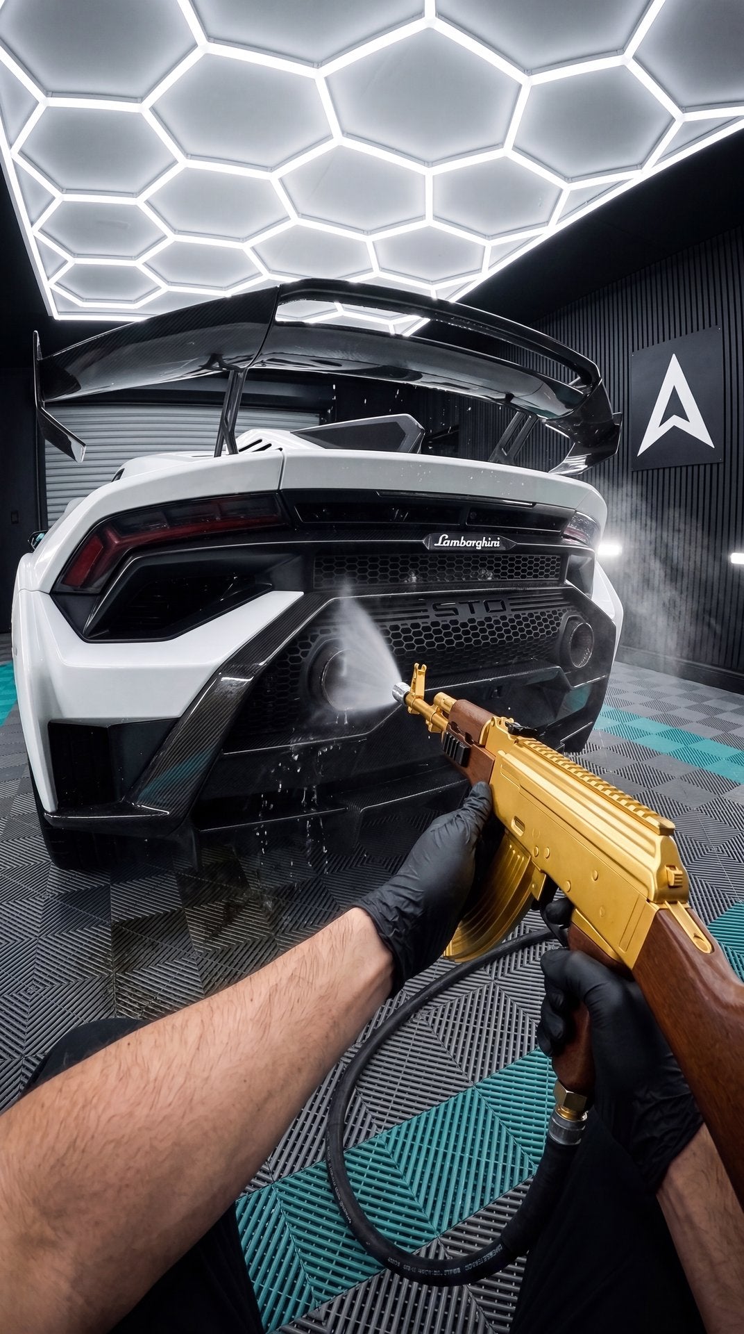 POV spraying the rear of a white supercar