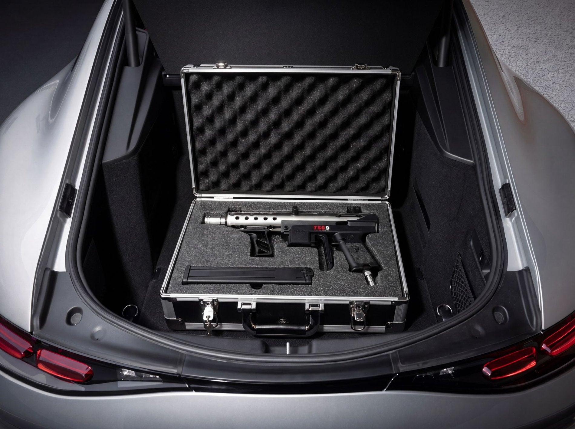 Sterling briefcase seated in a supercar trunk